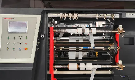 Side view of a servo motor mounted on a printing deck with encoder cable and cooling fins
